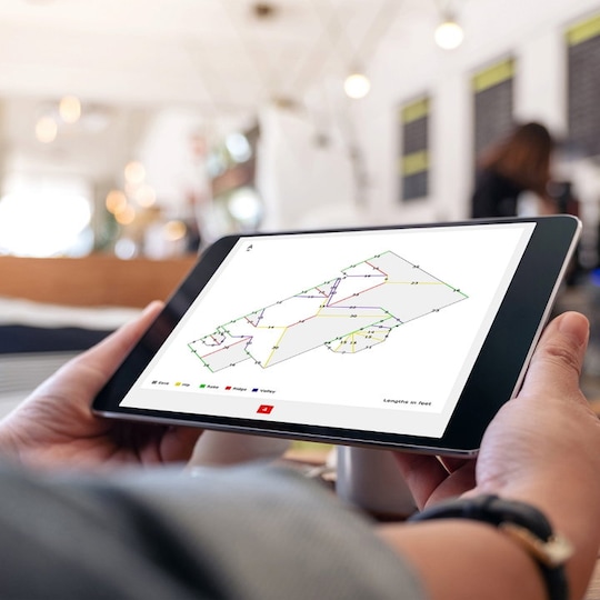 Hands hoding tablet with GAF QuickMeasure on screen