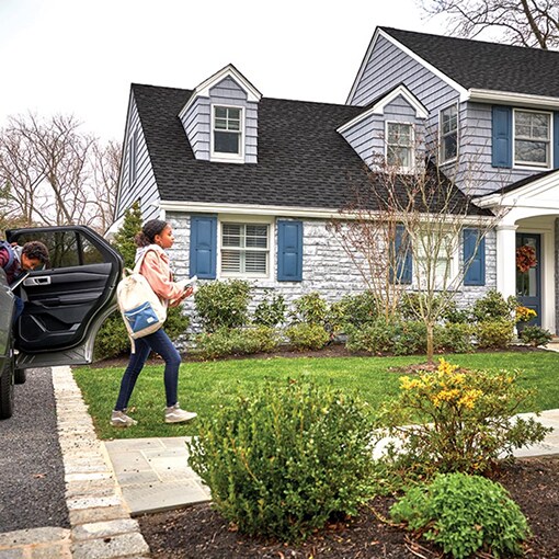 Homeowners existing car in front of a home with new GAF roof
