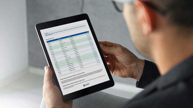 Contractor reviewing GAF QuickSite report on tablet